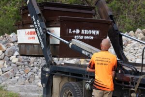 Employee Loading Skip Bin in Central Coast
