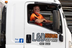 L&D Brown Skip Bins Worker Delivering a Skip Bin in Central Coast