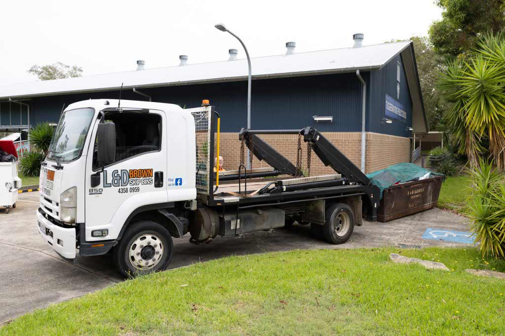 Flatbed Tow Truck Outside Building